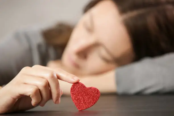 women holding glitter heart'